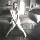Mia Villiers-Farrow on a bed