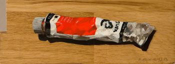 tube de peinture rouge sur planche de bois by Olivier Payeur